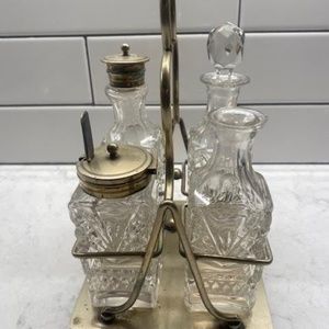 An antique Victorian silverplate and cut glass condiment caddy set